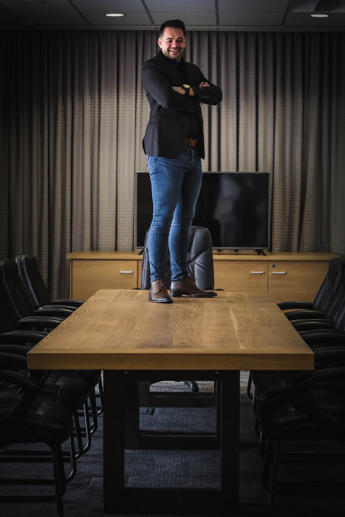 PG Paradigm standing on a table, speaking to an audience about human patterns